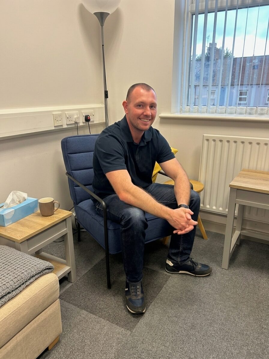 Shaun Carrigan sitting in his counselling room at Bourne House, Carlisle