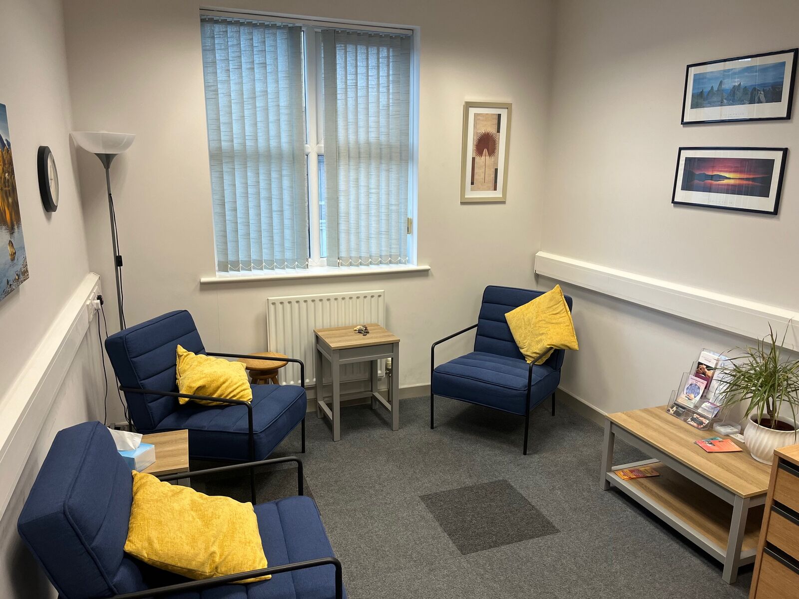 The counselling room at Bourne House: blue armchairs, yellow cushions and soft natural light